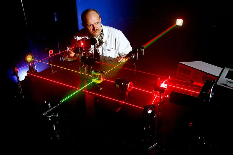 NORCO, Calif. (April 19, 2011) Daniel King, Microwave/Electro-Optic (MS32) electronics engineer at Naval Surface Warfare Center (NSWC), Corona Division, prepares alignment of various optical components using eye-safe visible lasers. Under the Navy Metrology Research and Development Program, NSWC Corona's E-O Group has developed and patented two calibration standards for support of laser designator and rangefinder test sets. The laser transmitter supports standards, keeps ordnance on target and reduces the cost of maintenance for the fleet. (U.S. Navy photo by Greg Vojtko/Released)