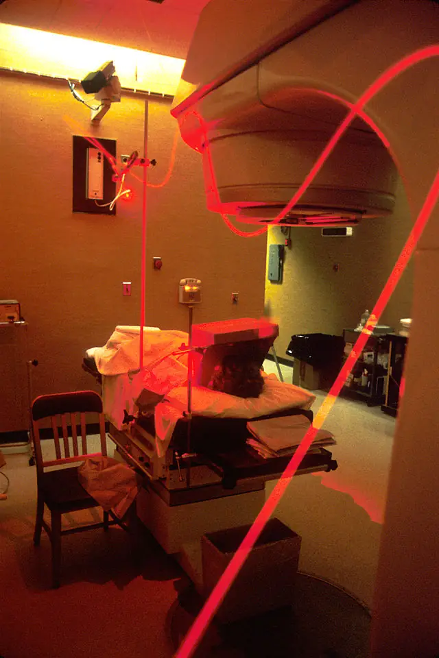 Seen is a "beam of light" traveling along fiber optics for photodynamic therapy for use in an operating room. Its source is a laser beam which is split at two different stages to create the proper "therapeutic wavelength". The patient has been given a photo sensitive drug containing cancer killing substances which are absorbed by cancer cells. During the surgery, the light beam is positioned at the tumor site, which then activates the drug that kills the cancer cells, thus photodynamic therapy.