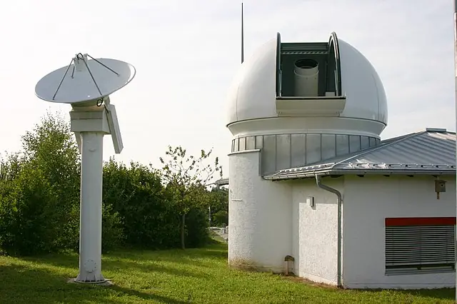 Wettzell Laser Ranging System (WLRS), the satellite and lunar laser ranging system of the geodetic observatory in Wettzell, Bavaria. The 75cm telescope in the dome is both used to send the laser pulses and to observe the reflected signal. The small radar dish besides the dome is used to monitor air traffic: The laser is automatically switched off when a aircraft approaches the target position of the laser.